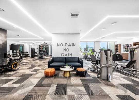 a workout room with a large sign that says no pain no gain
