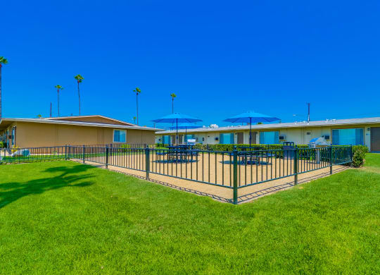 Exterior View of Las Brisas Apartments Building Surrounded By Lush Landscaping with View of Outdoor Picnic Area at Las Brisas Apartments, California