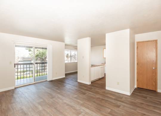 A room with a wooden floor and white walls.
