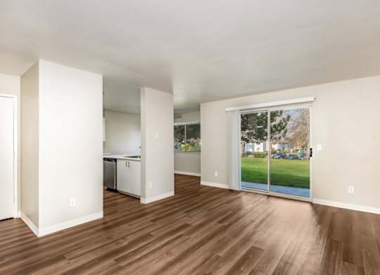A room with wooden floors and white walls.