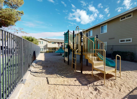 Playground with Jungle Gym in Sand Next to Apartment Buildings at Aspire High Desert Apartments, Victorville, California