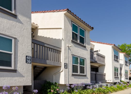a row of apartments with balconies and a sidewalk at Aspire Corona, Corona