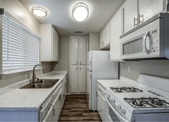 Kitchen With White Appliances at Aspire Seneca, Victorville