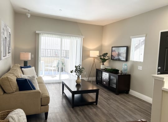 a living room with a couch and a coffee table at Riverton of the High Desert Apartments,Victorville, CA 92392