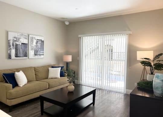a living room with a couch and coffee table at Riverton of the High Desert Apartments, California