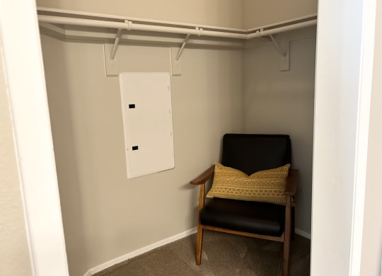 a chair in a large walk in closet at Riverton of the High Desert Apartments,Victorville, California