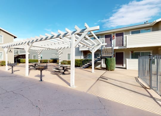 BBQ Area with Grill Stations and Picnic Seating Under a Pergola  at Aspire High Desert Apartments, Victorville, 92392