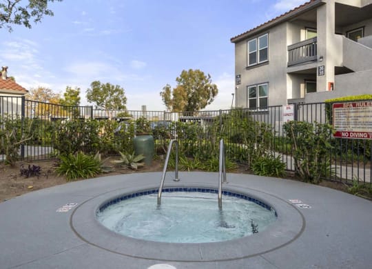 a hot tub with a fence in the background at Aspire Corona, Corona, 92882