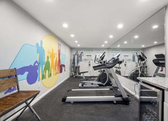 a gym with a colorful mural on the wall at Aspire Corona, Corona, CA