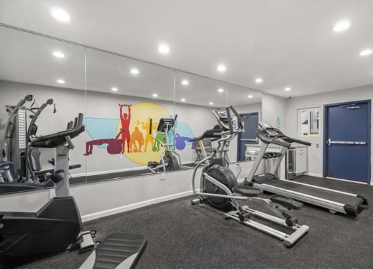 a gym with treadmills and other exercise equipment at Aspire Corona, California
