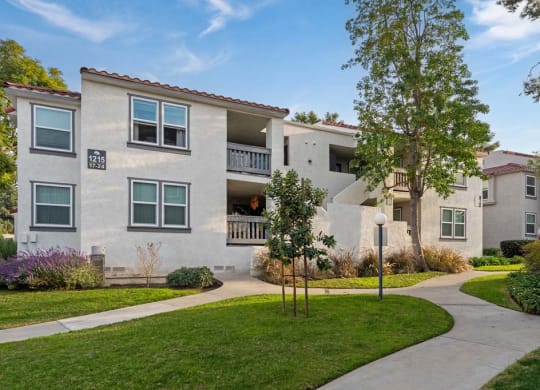 an apartment building with a sidewalk in front of it at Aspire Corona, California, 92882