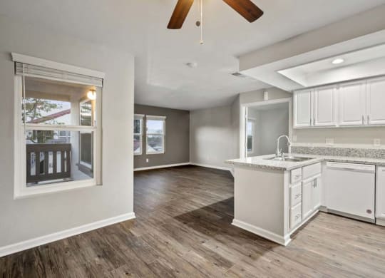 an empty kitchen and living room with a ceiling fan at Aspire Corona, Corona California