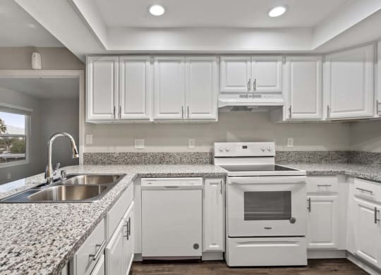 a kitchen with a sink stove and dishwasher at Aspire Corona, California, 92882