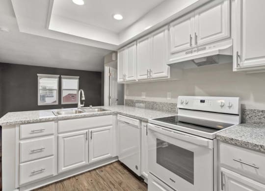 a kitchen with a stove top oven next to a sink at Aspire Corona, Corona, 92882