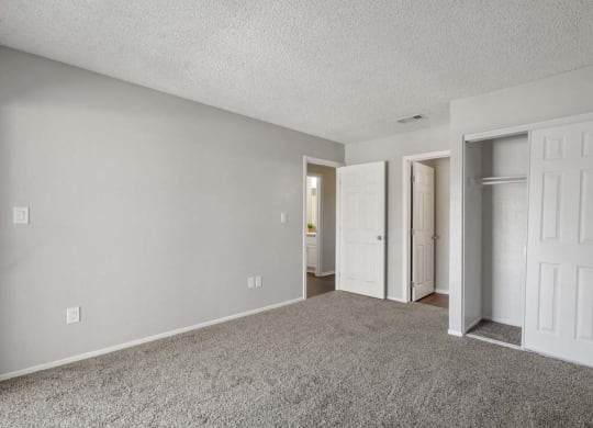 a bedroom with two doors and a carpeted floor at Aspire Redlands, Redlands, 92374