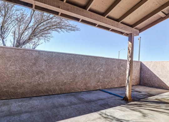 the patio of a building with a concrete wall and a wooden poleat Aspire Seneca at Aspire Seneca, Victorville, California
