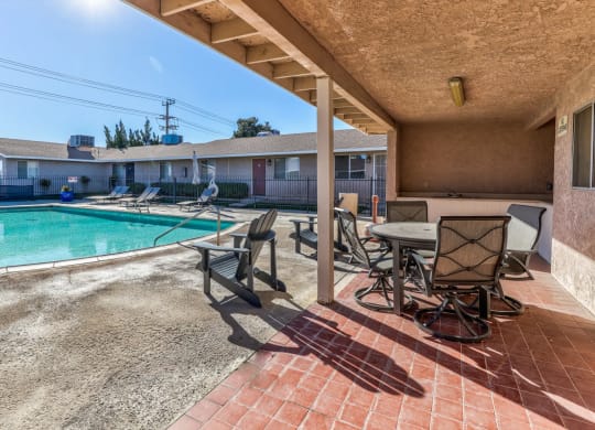 pool and a patio with chairs and tablesat Aspire Seneca, Victorville, 92392
