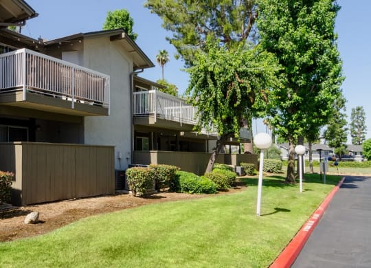 a building with a lawn and trees in front of it at Aspire Redlands, California, 92374