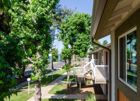 the front porch of a house with trees and a sidewalk at Aspire Redlands, Redlands, CA
