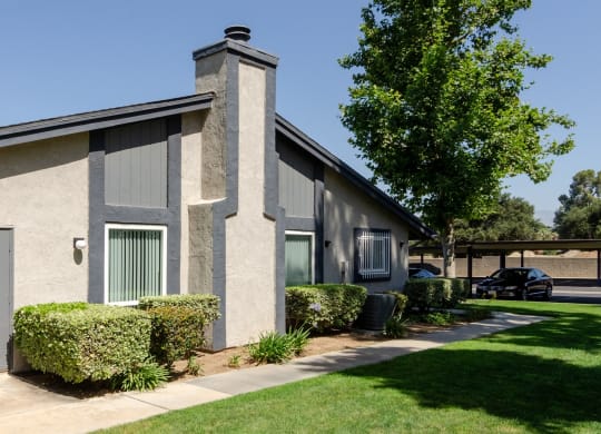 the exterior of a building with a lawn and trees at Aspire Redlands, Redlands, CA