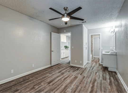 an empty living room with a ceiling fanat Aspire Seneca, Victorville, CA
