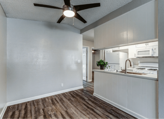 an open kitchen and living room with a ceiling fan at Aspire Seneca, Victorville, 92392