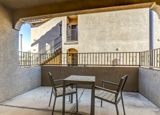 a table and chairs on a balcony at Riverton of the High Desert Apartments, California, 92392