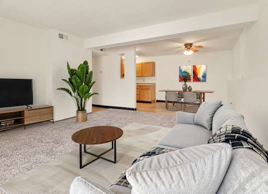 A living room with a grey couch and a wooden coffee table at Winding Hills Apartments, Davenport , IA, 52807