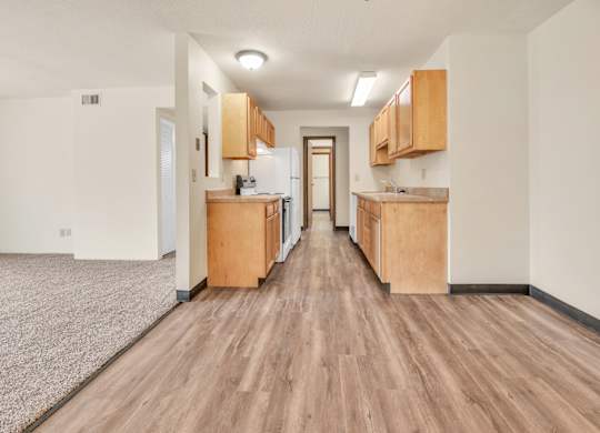A long, narrow apartment with wood floors and cabinets. at Winding Hills Apartments, Iowa, 52807