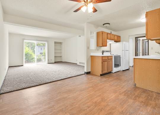 A room with wooden floors and a ceiling fan. at Winding Hills Apartments, Davenport