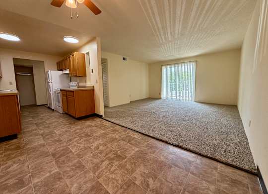 A room with a ceiling fan and a window with blinds. at Winding Hills Apartments, Davenport  52807