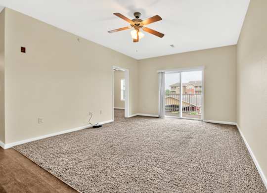 Carpeted Living Area With Ceiling Fan at Deer Valley Apartments, Illinois, 61282