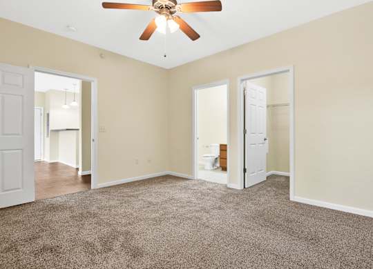A room with a ceiling fan and carpeted floor. at Deer Valley Apartments, Illinois