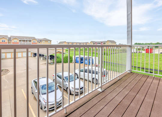 A parking lot with cars and apartment buildings in the background. at Deer Valley Apartments, Silvis, 61282