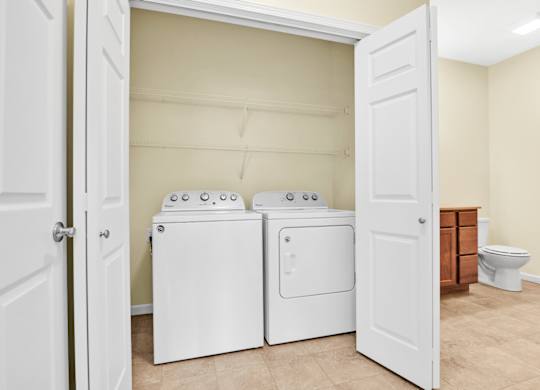 A laundry room with a washer and dryer in it. at Deer Valley Apartments, Silvis, 61282