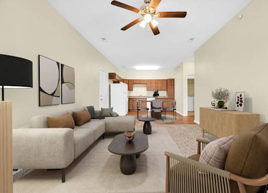 A living room with a beige couch, a brown chair, and a ceiling fan. at Deer Valley Apartments, Illinois