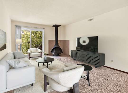 A living room with a fireplace and a television. at Indian Ridge Apartments, Davenport, IA