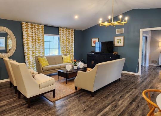 a living room with blue walls and white furniture at Sunscape Apartment Homes, Tampa, 33613