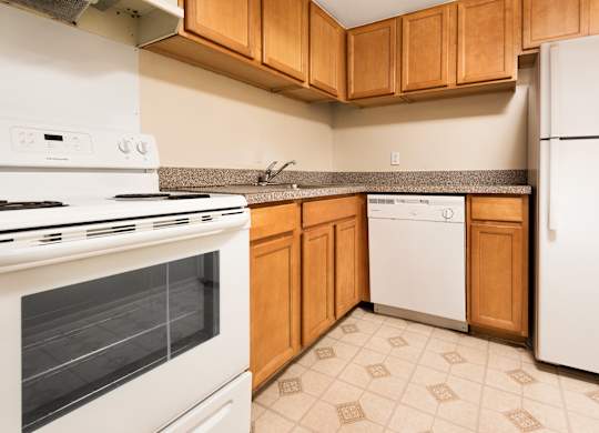 A kitchen with a white stove and white refrigerator.