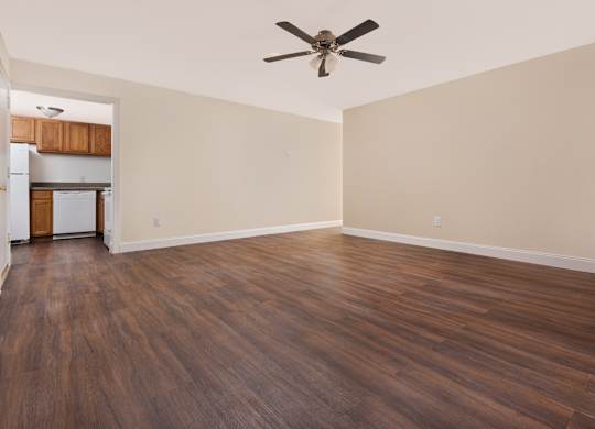 A room with wooden floors and a ceiling fan.