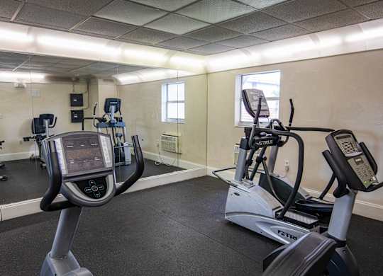 A gym with treadmills and elliptical machines.