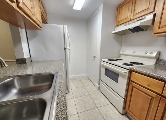 a kitchen with a stove refrigerator and sink at Sunscape Apartment Homes, Tampa, FL