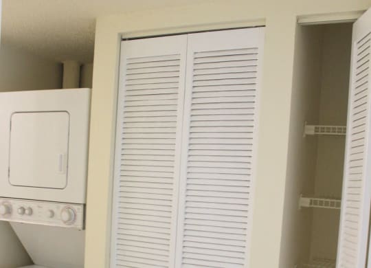 a closet with white shutters in a laundry room at Sunscape Apartment Homes, Tampa, FL