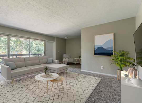 A living room with a grey sofa, a white coffee table, and a painting on the wall.