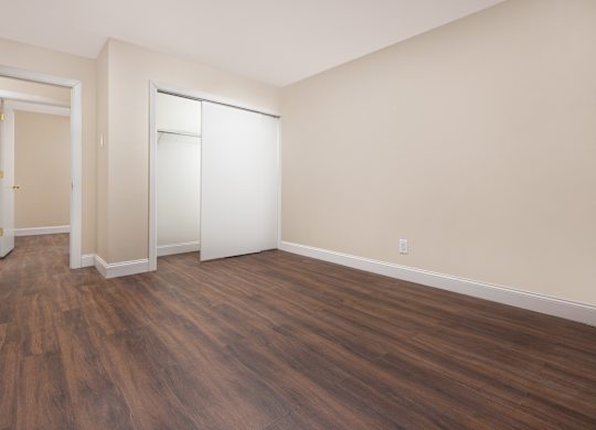 A room with wooden floors and white walls.