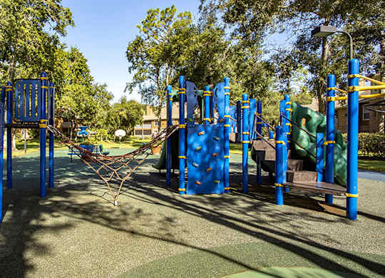 A playground with blue and yellow equipment.