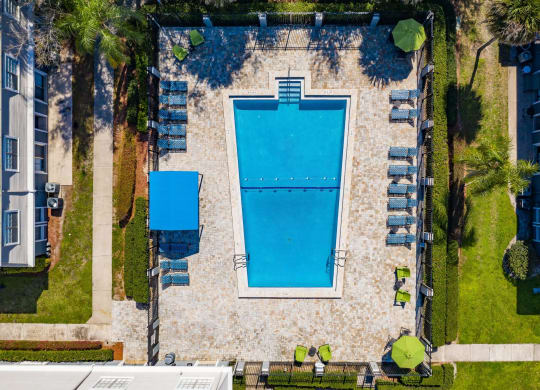 an aerial view of a swimming pool with chairs and umbrellas around it  at The Park at Chesterfield Apartment Homes, Tampa