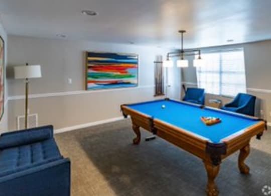 a living room with a blue pool table  at The Park at Chesterfield Apartment Homes, Tampa, FL, 33617