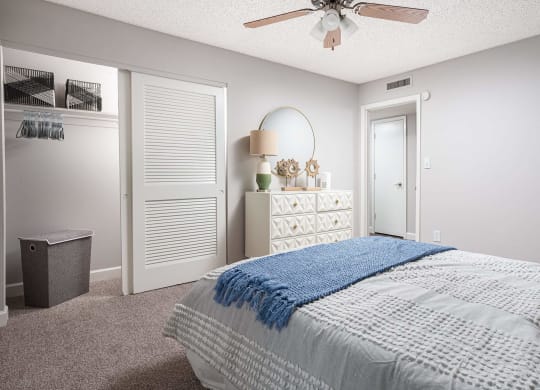 a bedroom with a bed and a ceiling fan  at The Park at Chesterfield Apartment Homes, Tampa