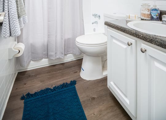 a white bathroom with a shower and a toilet  at The Park at Chesterfield Apartment Homes, Tampa